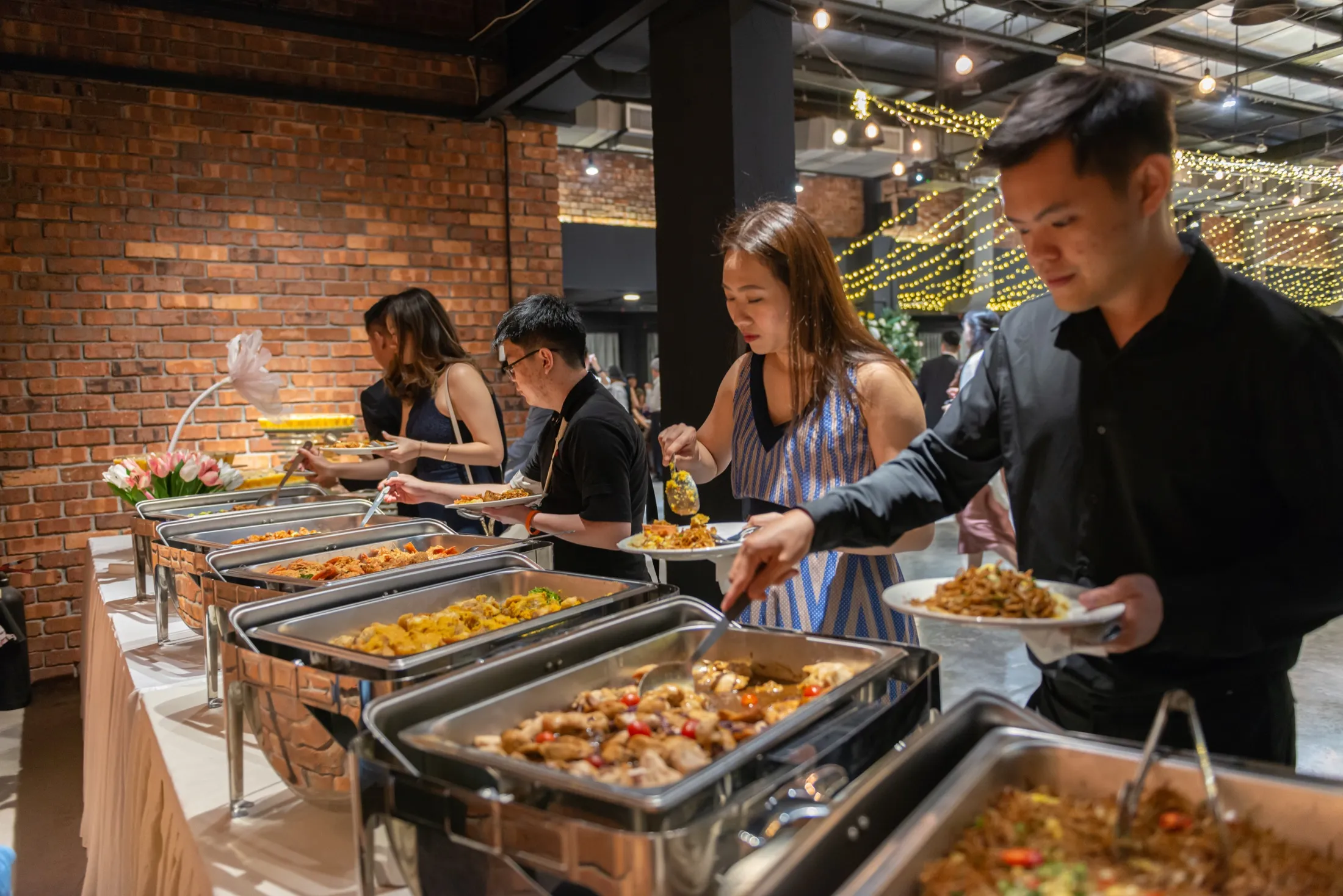 Guests being served buffet catering at a wedding event