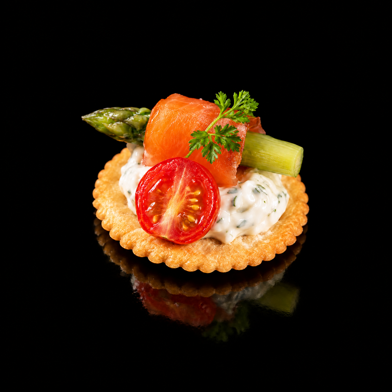 salmon rolled with asparagus with cream cheese on top of cracker