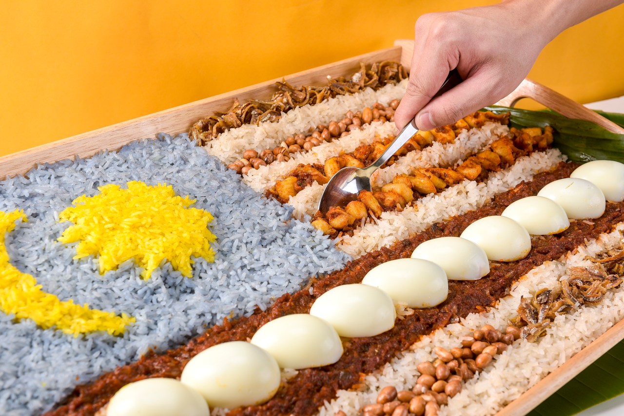 a spoon of nasi lemak platter