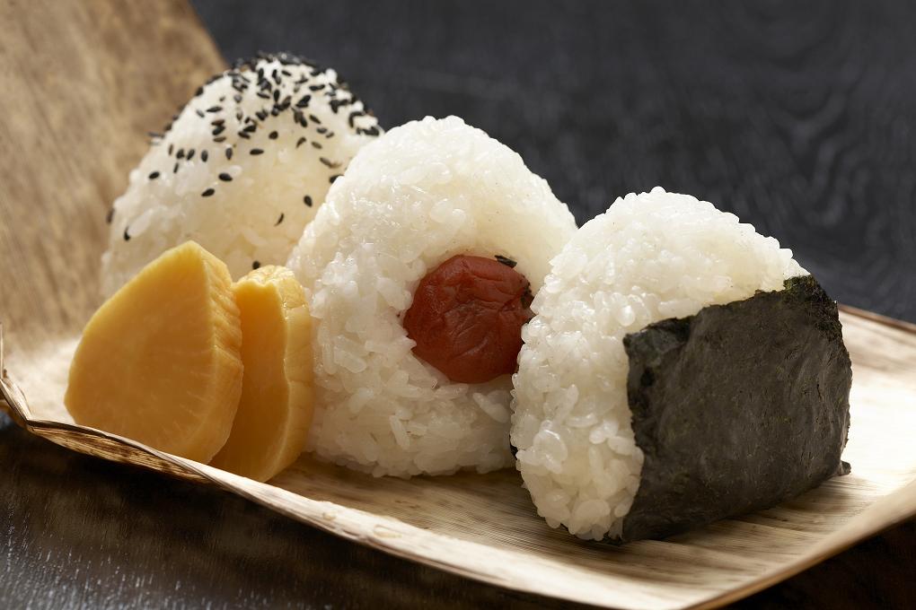 salted onigiri with plum on a wooden plate
